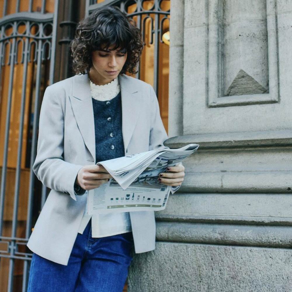 lady reading a newspaper with stylish and fashion clothes