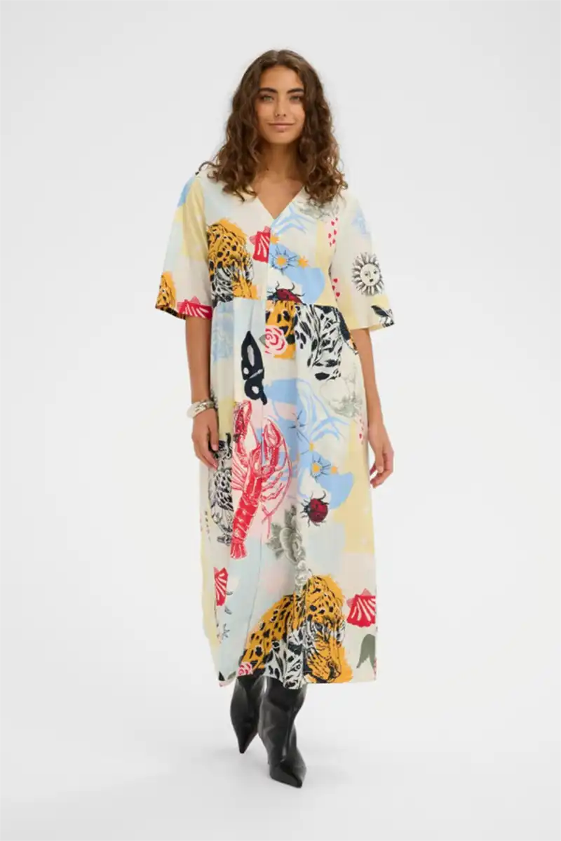 Woman wearing a colorful patterned dress on a white background